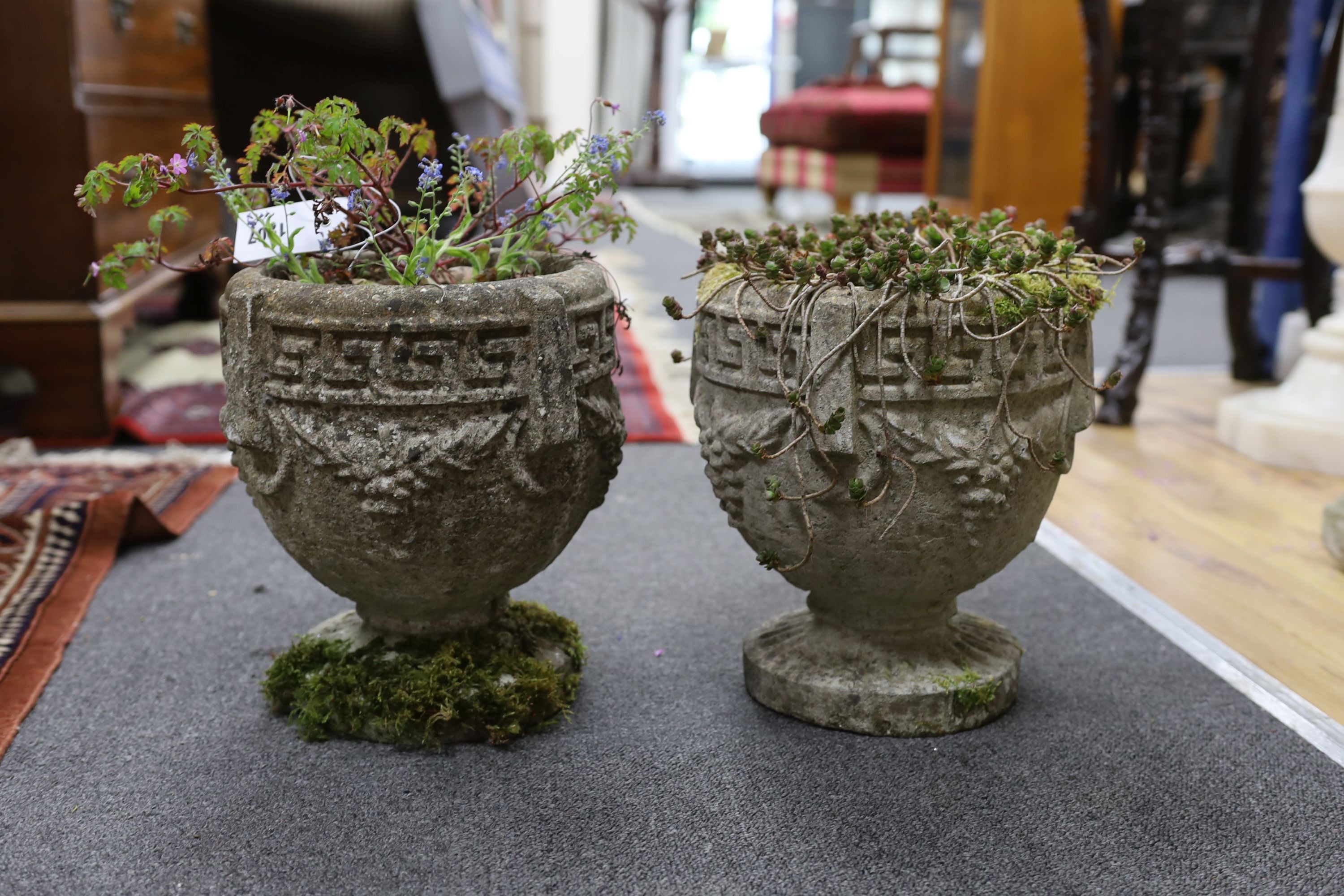 A pair of small reconstituted stone circular garden planters, diameter 23cm, height 28cm